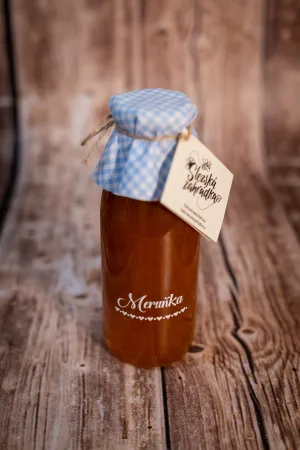 Meruňkový ovocný sirup ve skleněné lahvi s modře kostkovaným víčkem a visačkou Slezská zahrádka