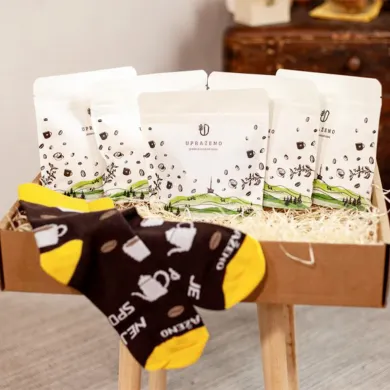 Dárkový balíček čtyři bílé sáčky s motivem kávy krabice se slámou a ponožky černé s žlutými špičkami
